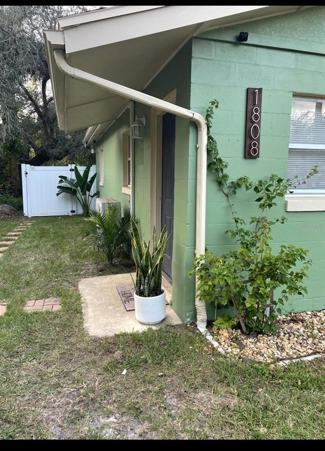 view of property exterior with a lawn