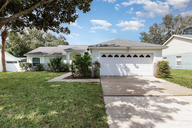 ranch-style house featuring a garage and a front lawn