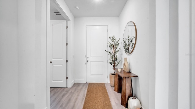 corridor with light wood-type flooring