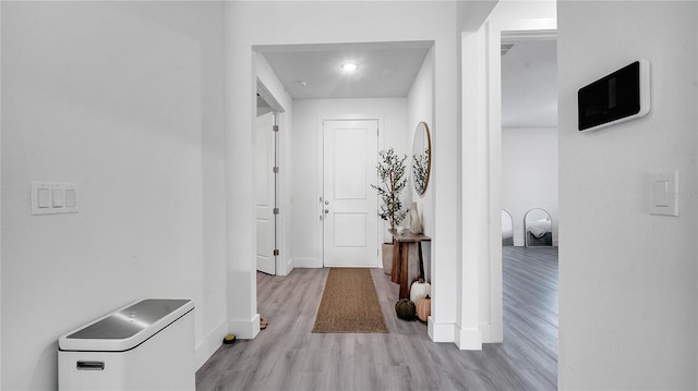 hallway with light hardwood / wood-style flooring