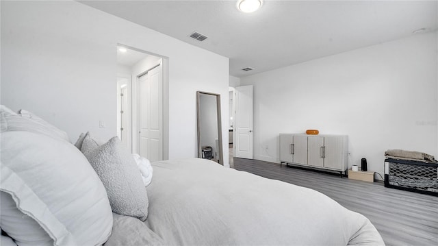 bedroom with dark hardwood / wood-style floors