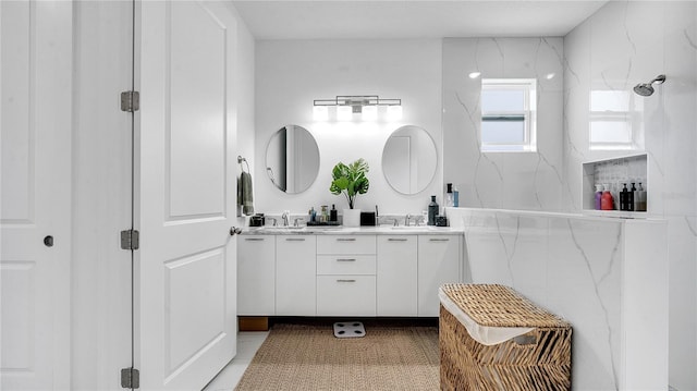 bathroom featuring walk in shower and vanity