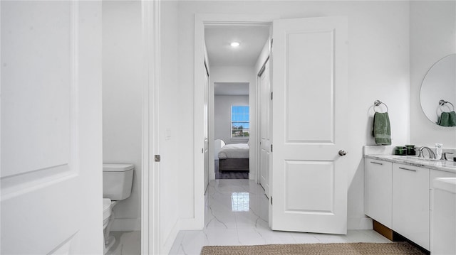 bathroom with toilet and vanity