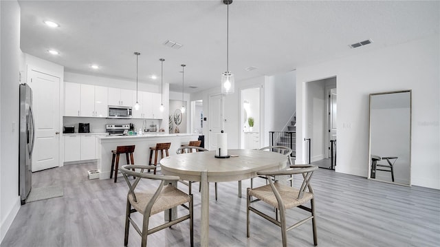 dining room with light hardwood / wood-style flooring