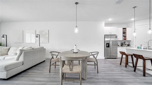 dining space with light hardwood / wood-style flooring