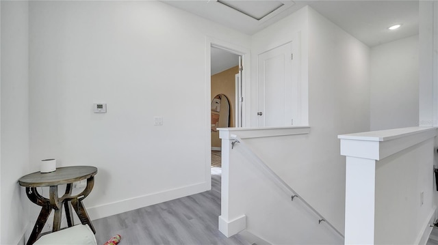 staircase with hardwood / wood-style flooring