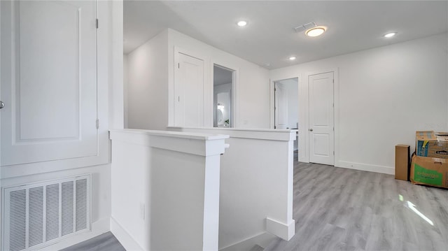 kitchen featuring light wood-type flooring and kitchen peninsula