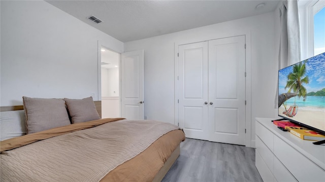 bedroom featuring a closet and light hardwood / wood-style flooring