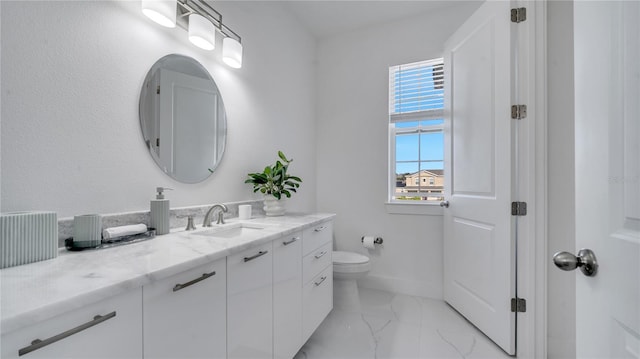 bathroom featuring toilet, a healthy amount of sunlight, and vanity