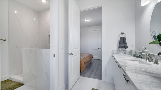 bathroom with vanity and a shower