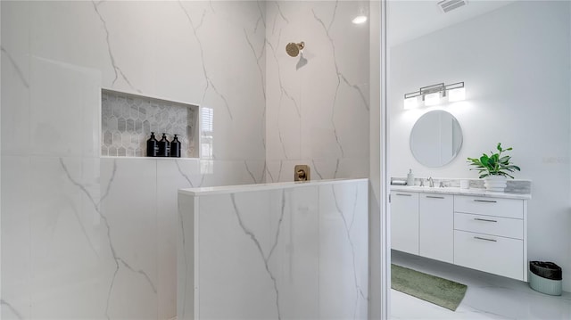 bathroom featuring vanity and a tile shower