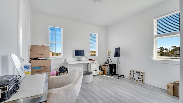 office area with a wealth of natural light and light hardwood / wood-style floors