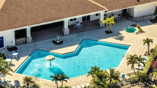 view of pool featuring a patio area and a hot tub