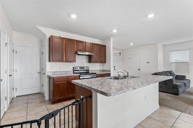 kitchen with sink, stainless steel electric range, light tile patterned floors, a textured ceiling, and a center island with sink