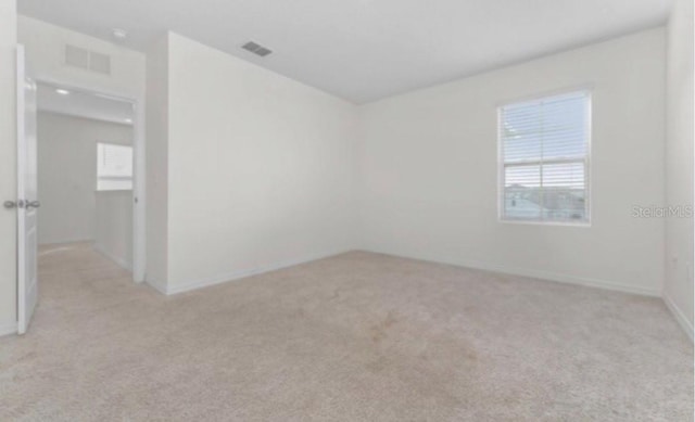 unfurnished room with light colored carpet