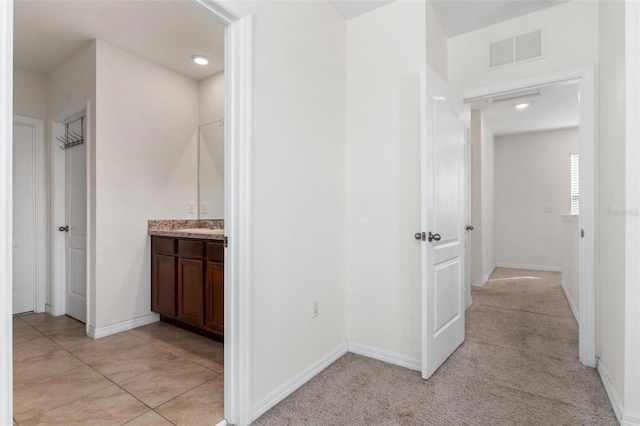 corridor featuring light tile patterned floors