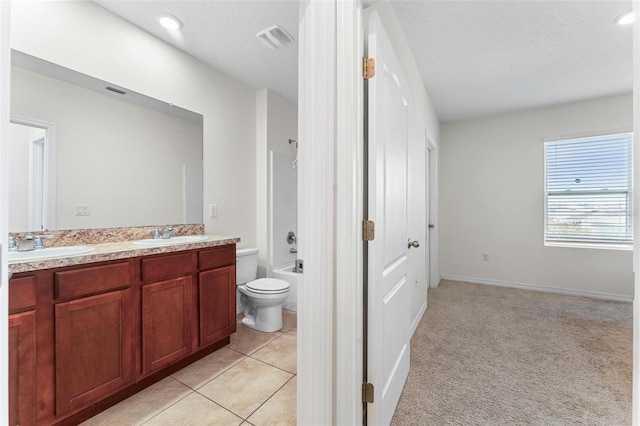 full bathroom with tile patterned flooring, vanity, toilet, tub / shower combination, and a textured ceiling