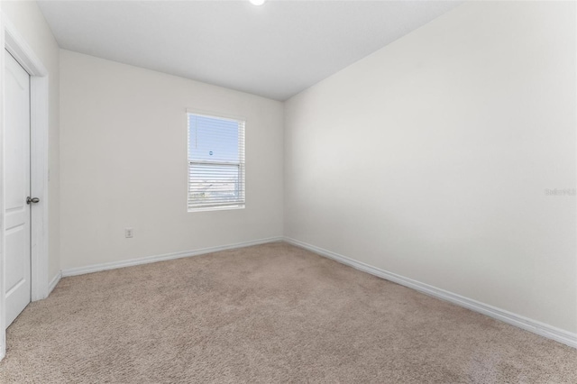 unfurnished room featuring light carpet