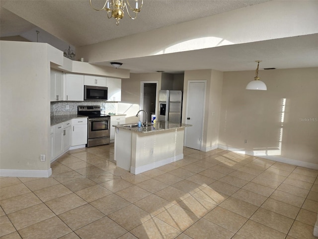 kitchen featuring white cabinetry, appliances with stainless steel finishes, tasteful backsplash, and hanging light fixtures