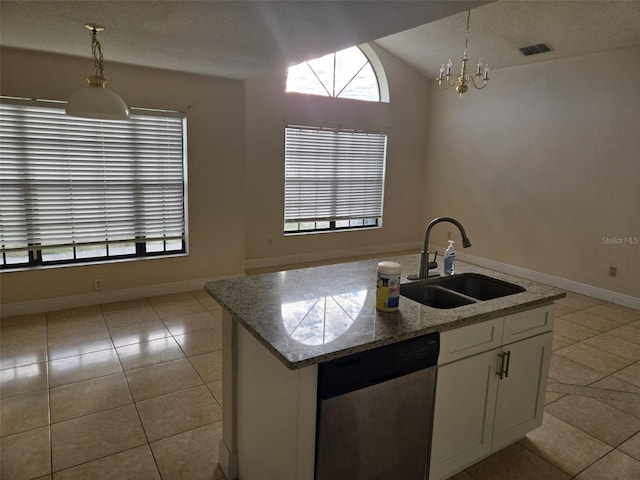 kitchen featuring dishwasher, pendant lighting, sink, white cabinetry, and light stone counters