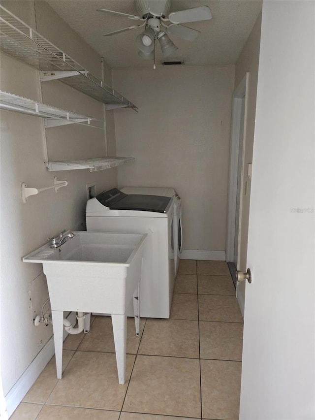 washroom featuring ceiling fan, light tile patterned flooring, and washing machine and clothes dryer