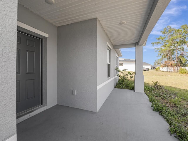 view of exterior entry with a patio