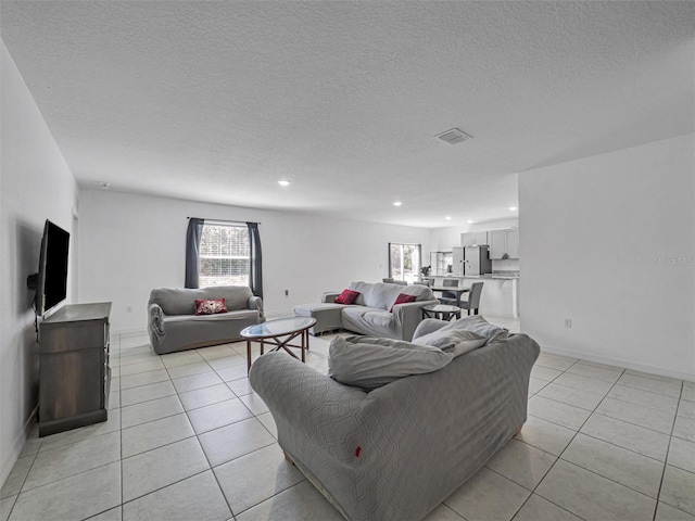 living room featuring light tile patterned floors and a textured ceiling