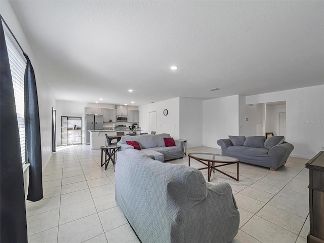 tiled living room with a wealth of natural light and a textured ceiling