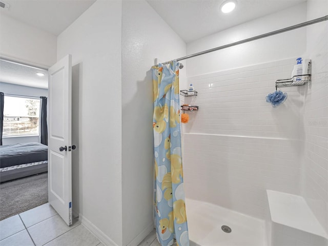 bathroom with tile patterned floors and curtained shower