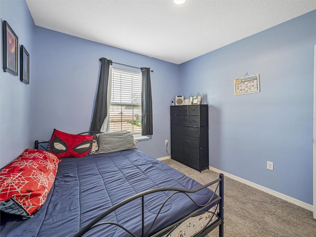 bedroom with a textured ceiling and carpet flooring