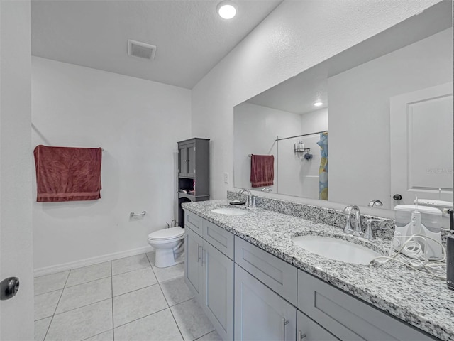 bathroom featuring toilet, tile patterned flooring, walk in shower, a textured ceiling, and vanity