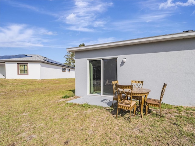 back of house with a lawn