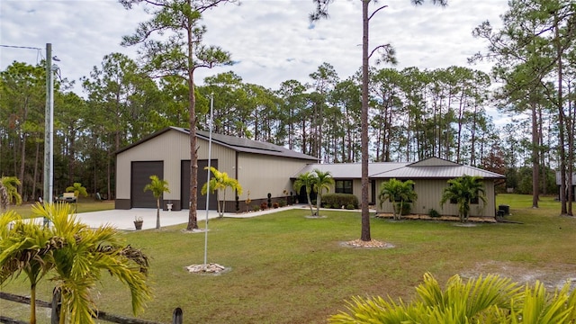 view of front of home with a front yard and a garage