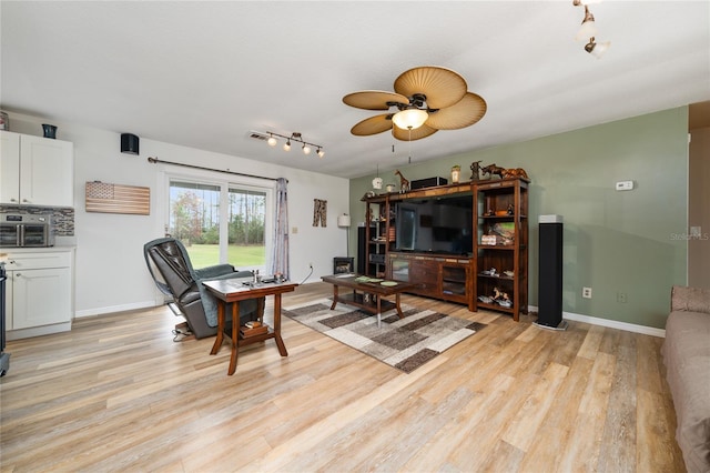 living room with ceiling fan and light hardwood / wood-style floors