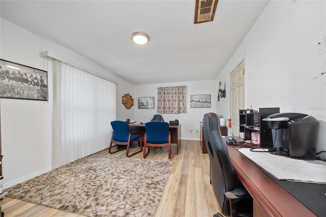 home office with hardwood / wood-style flooring