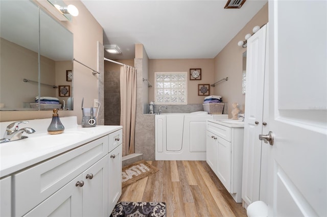 bathroom with vanity, a shower with shower curtain, and hardwood / wood-style floors