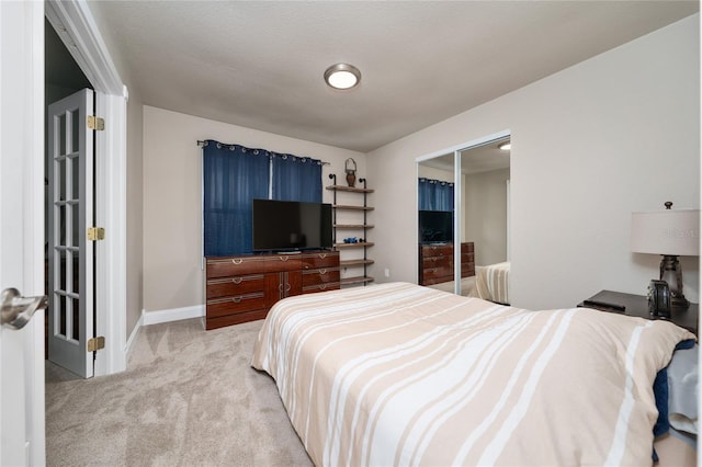 carpeted bedroom featuring a closet and a textured ceiling