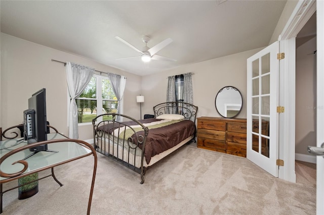 bedroom with ceiling fan and light carpet