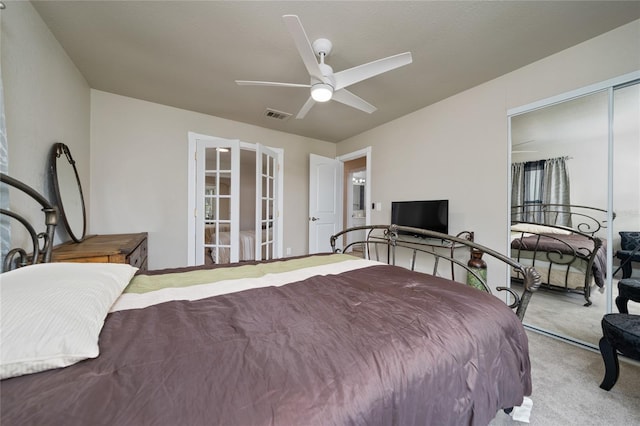 carpeted bedroom with a closet, french doors, and ceiling fan