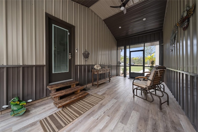 sunroom featuring ceiling fan, vaulted ceiling, and wood ceiling