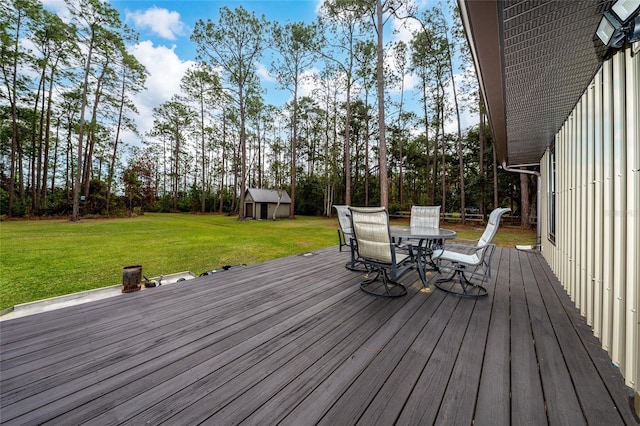 deck with a storage shed and a yard