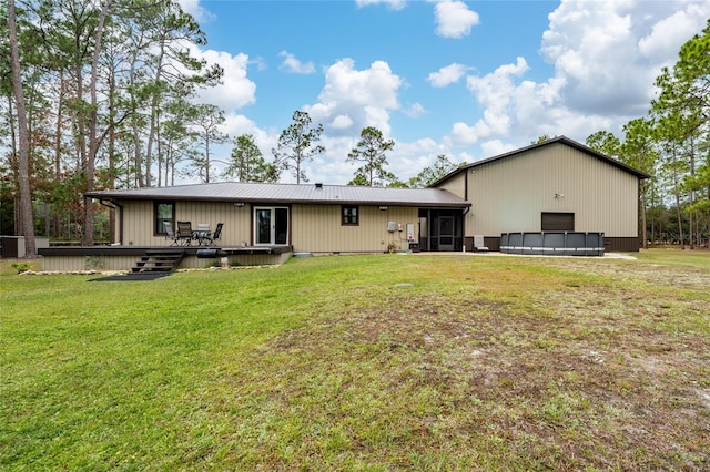 back of house with a yard, a swimming pool side deck, and a sunroom