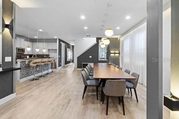 dining space featuring sink and light hardwood / wood-style floors