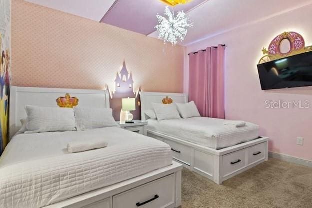 carpeted bedroom featuring a notable chandelier