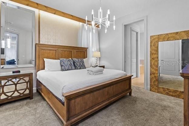 bedroom with a chandelier and light carpet