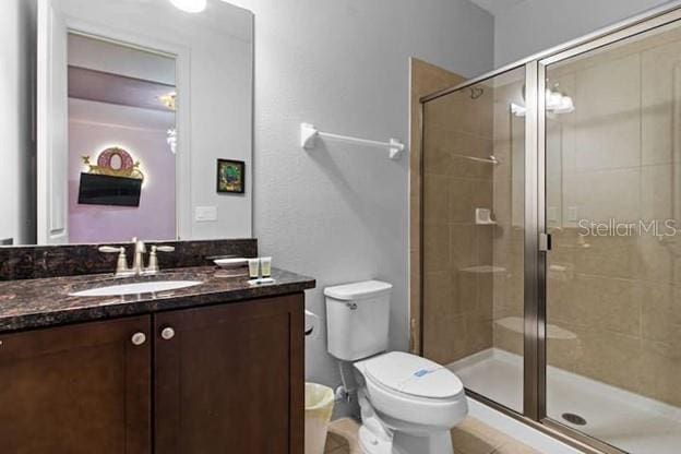 bathroom with vanity, toilet, and an enclosed shower