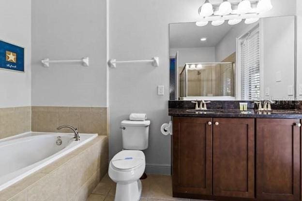 full bathroom featuring shower with separate bathtub, vanity, tile patterned floors, and toilet