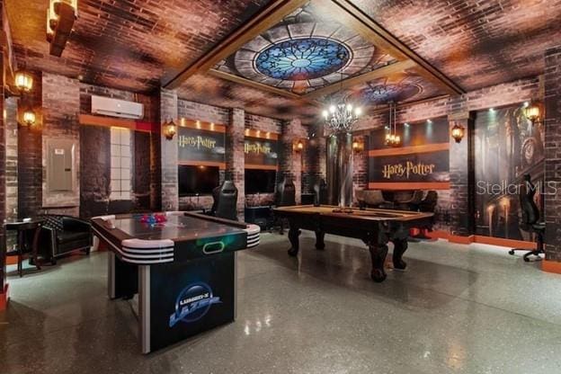 game room featuring brick ceiling, pool table, a wall mounted air conditioner, electric panel, and brick wall