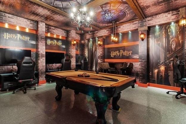 rec room featuring beam ceiling, pool table, and brick wall