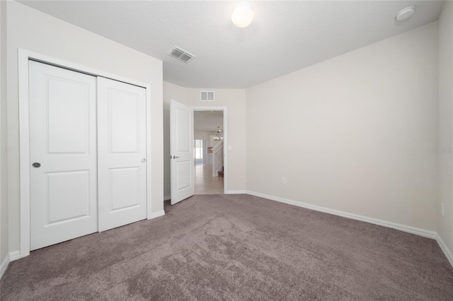 unfurnished bedroom featuring a closet and carpet